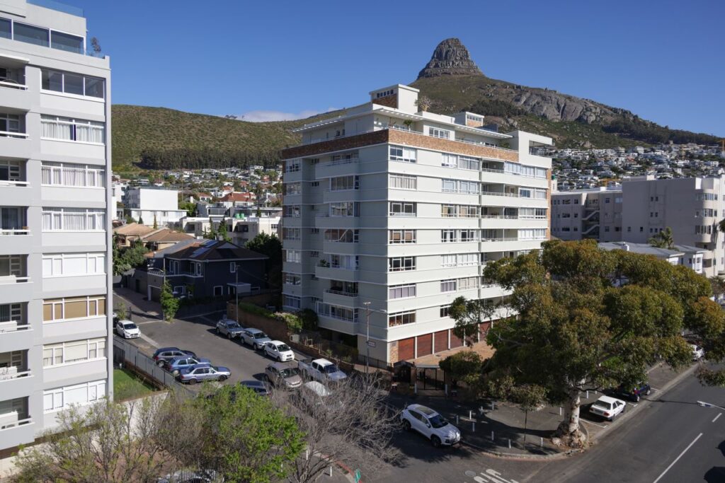 Aerial view of Cape Town's cityscape featuring Lion's Head and modern buildings.
